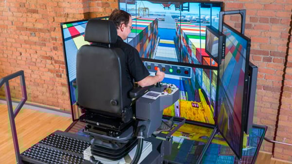 A man operating a haptic training simulator